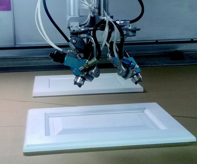 Automatic airspray gun on flat line Automatic airspray gun on flat line